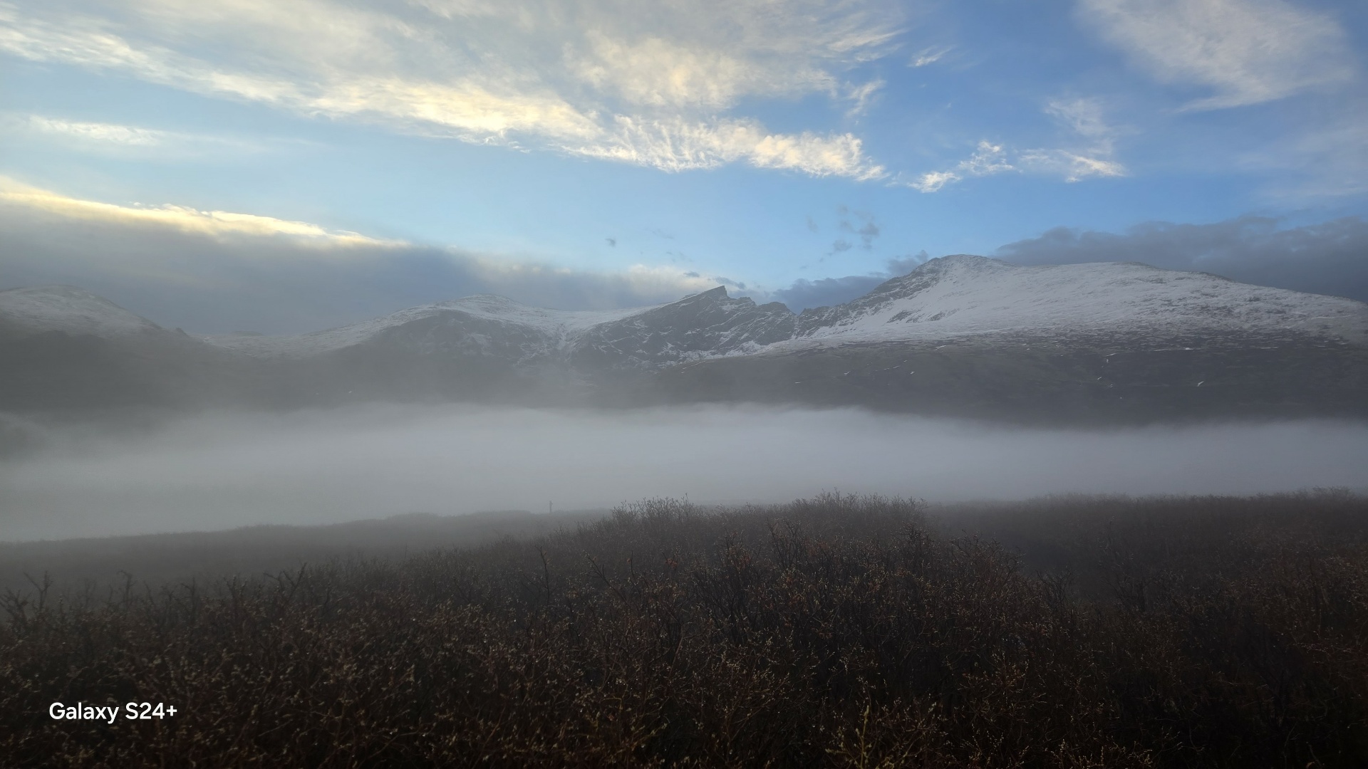 Foggy start below Mt. Bierstadt with snow-covered slopes in the distance